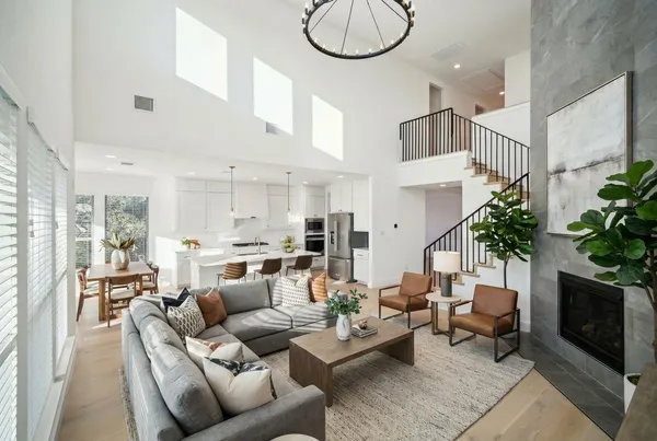 a living room with furniture a large window and a fireplace