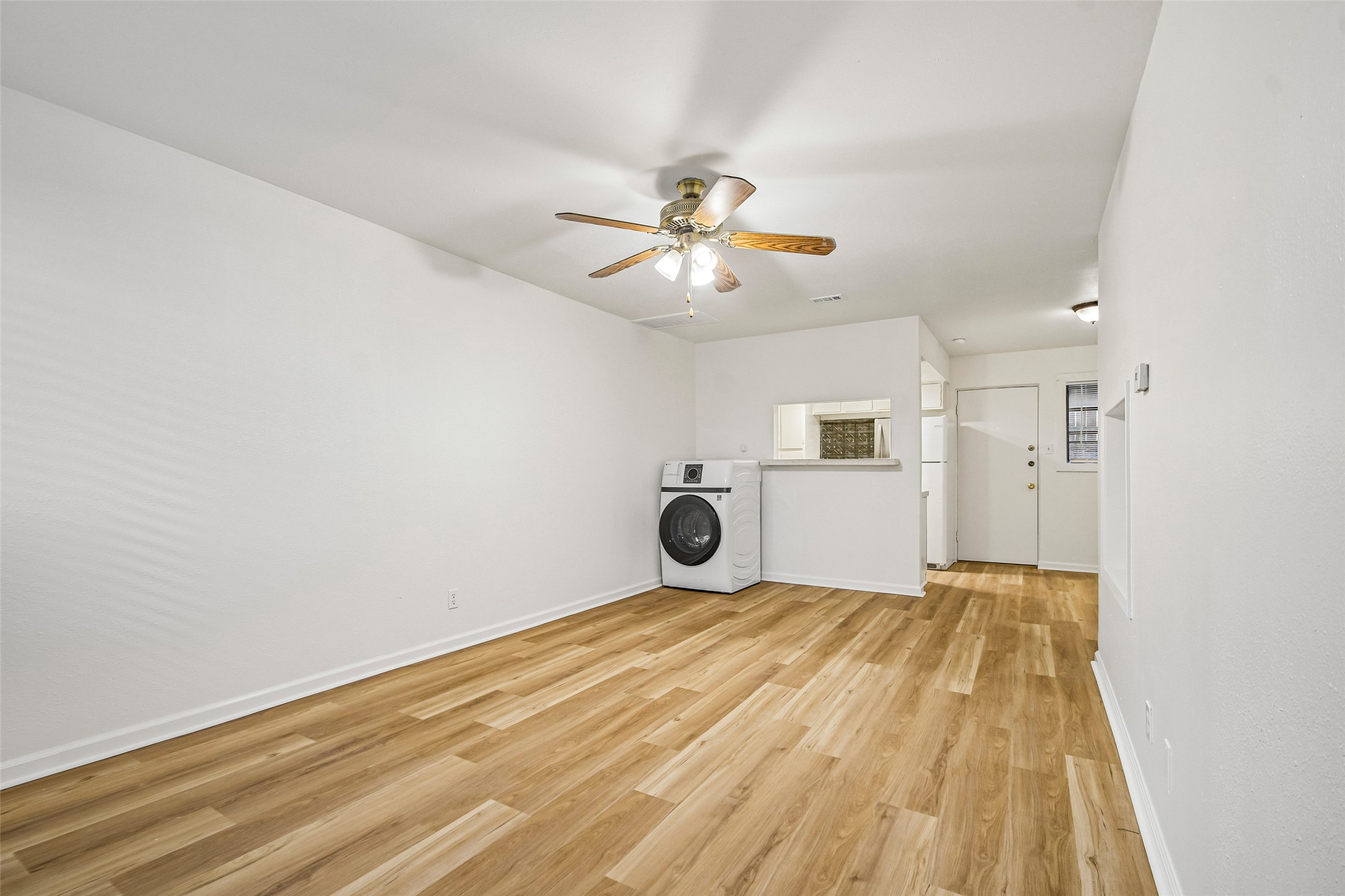 2413 Leon Street, Unit 104 Austin, TX 78705 - Photo 6 of 26 a view of a bedroom with a bed and a ceiling fan