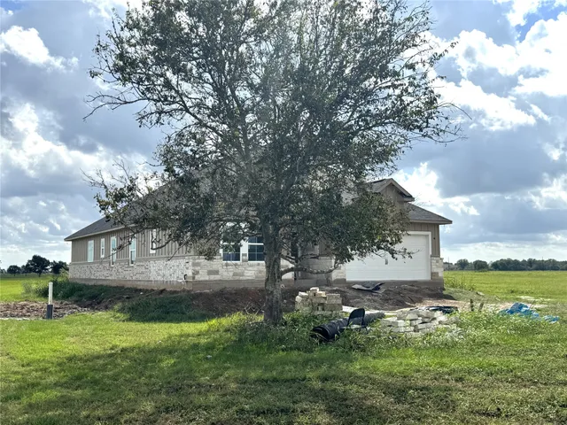 a view of backyard of house with green space
