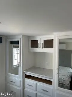 a view of room with cabinets and wooden floor
