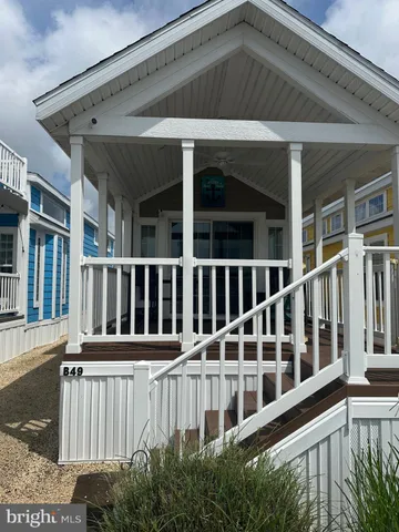 a view of a house with wooden deck