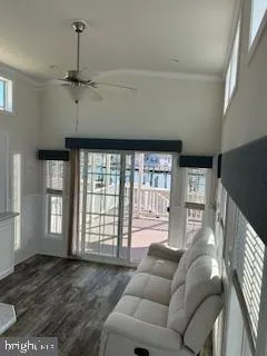 a living room with furniture and a floor to ceiling window