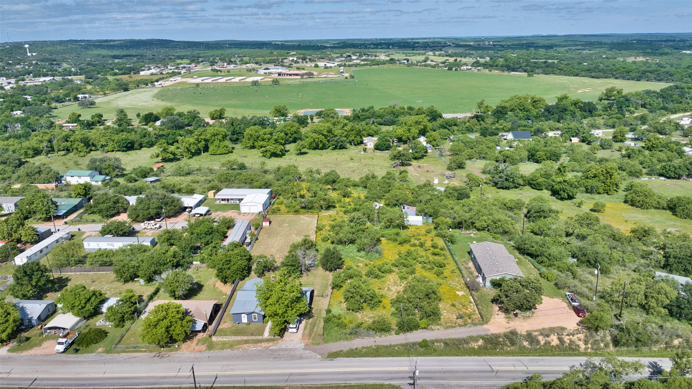 904 Bluebonnet Road Mason, TX 76856 - Photo 5 of 28 Expansive land parcel featuring existing structures, mature trees, and a road frontage