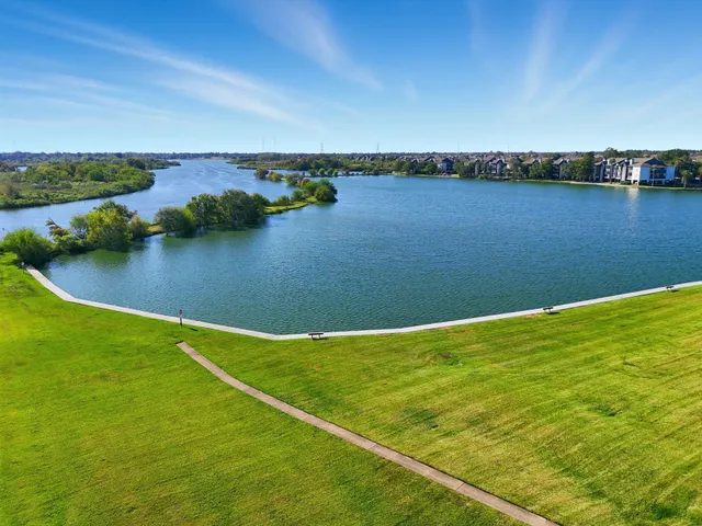 a view of a lake with houses in the back
