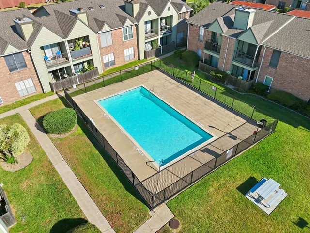 an aerial view of a residential apartment building with a yard