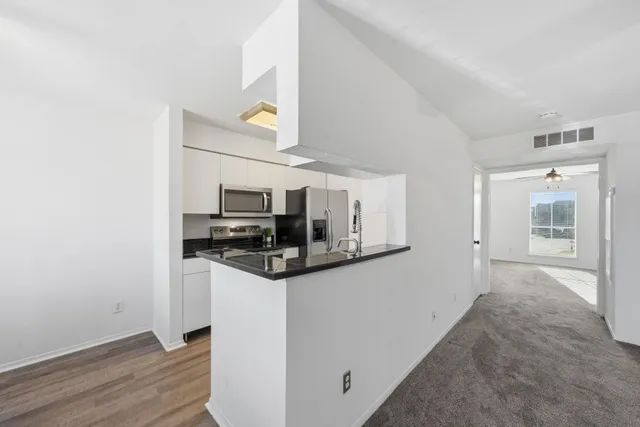 a kitchen with stainless steel appliances granite countertop a stove and a refrigerator