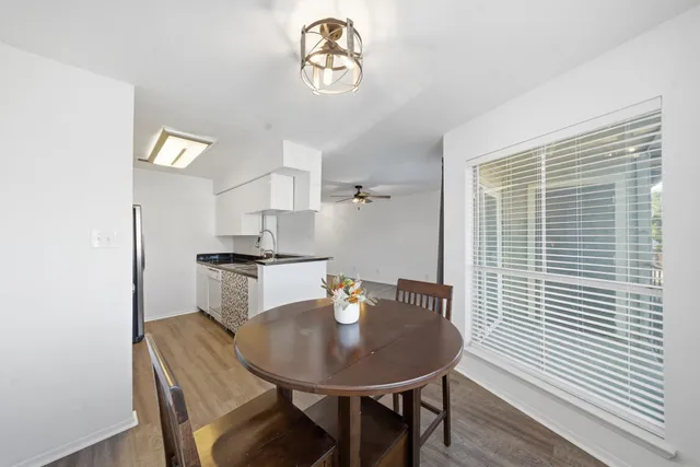 a view of a dining room with furniture and wooden floor