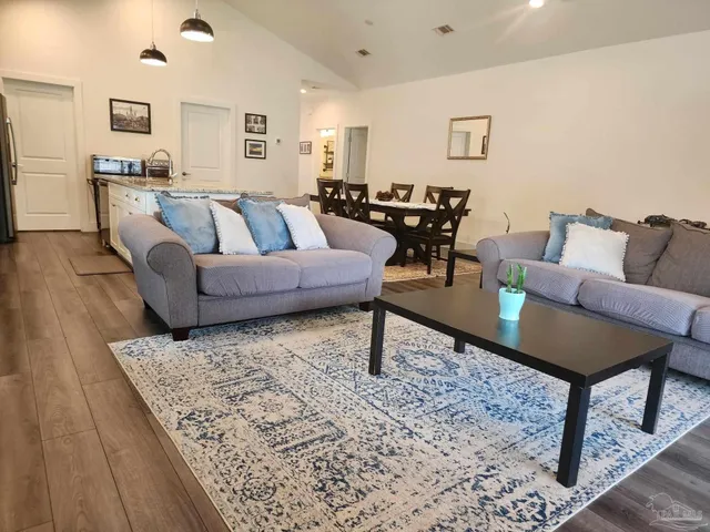 a living room with furniture and a rug