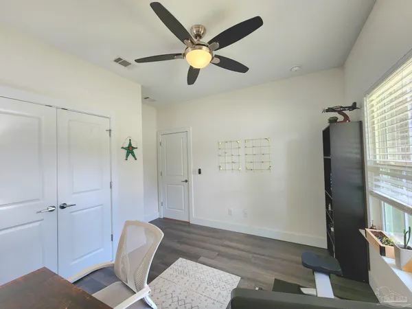 a view of an empty room and wooden floor