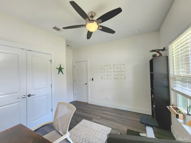 a view of an empty room and wooden floor