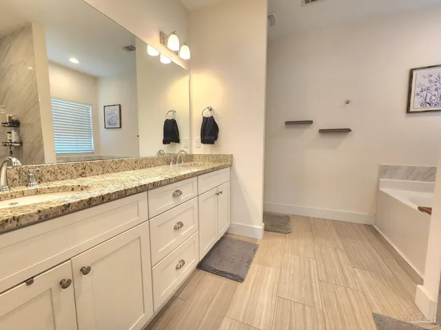 a bathroom with a sink a mirror and a shower