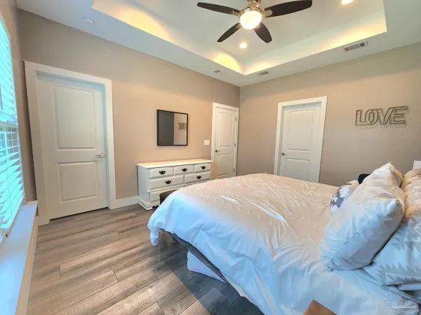 a bedroom with a bed and a ceiling fan
