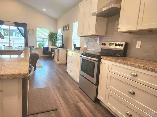 a kitchen with granite countertop stainless steel appliances and wooden cabinets
