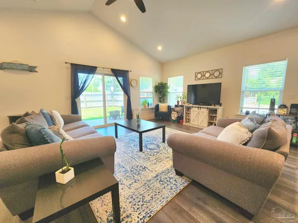 a living room with furniture and a large window