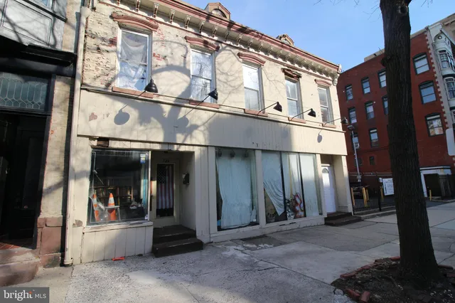 a front view of a building with retail shops