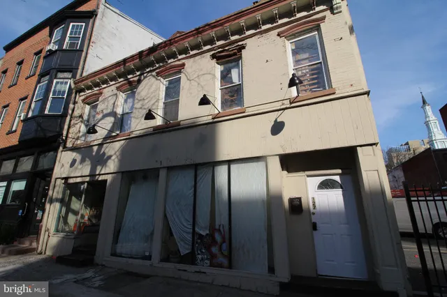 a close view of a refrigerator a kitchen and wooden floor