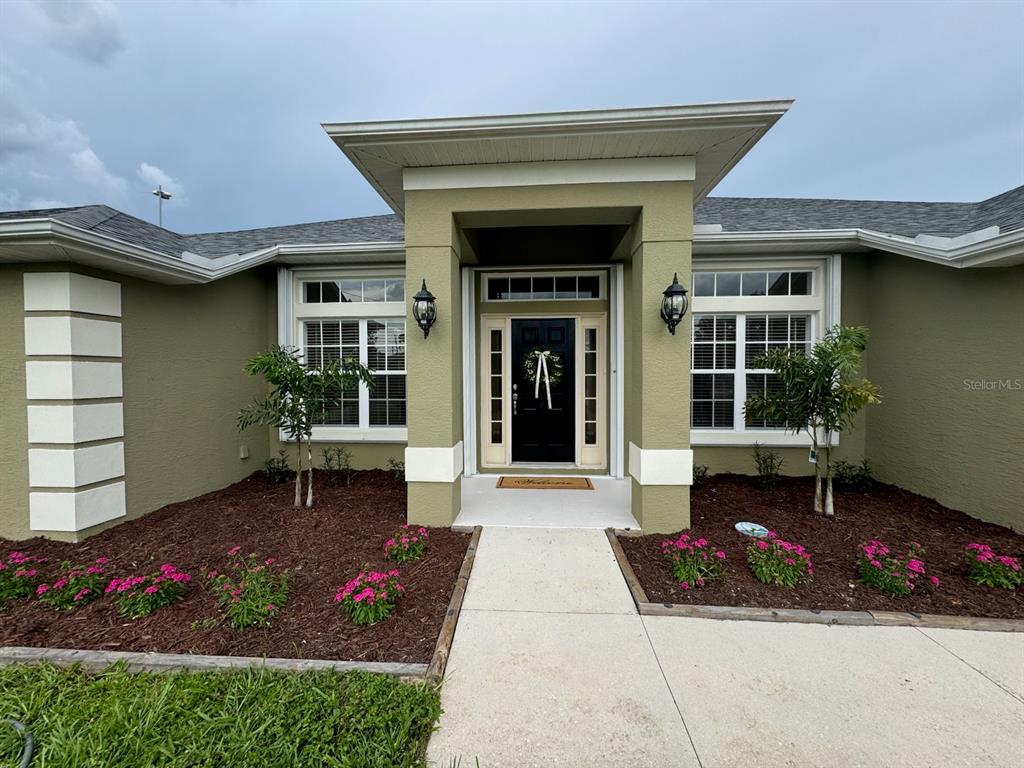 4662 Oakley Road North Port, FL 34288 - Photo 1 of 1 a front view of a house with a garden