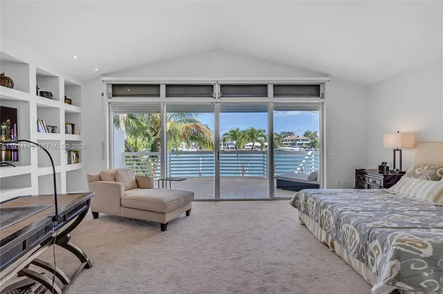 a bedroom with a bed and a balcony