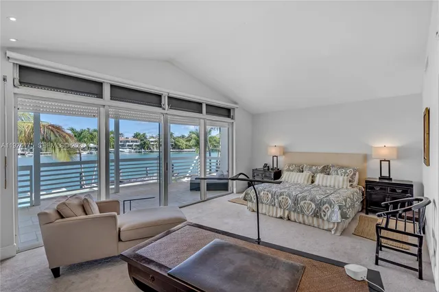 a bedroom with furniture and a large window