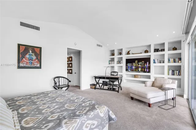 a bedroom with furniture and a book shelf