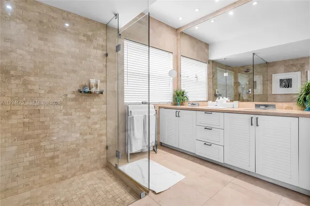 a spacious bathroom with a granite countertop sink mirror and shower