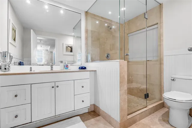 a bathroom with a shower sink and mirror