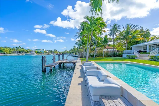 a view of a swimming pool with a table and chairs