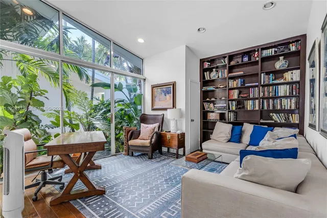 a living room with furniture and a book shelf