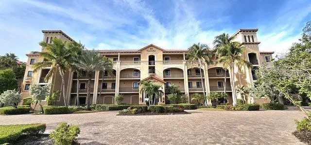 front view of a brick house with a yard