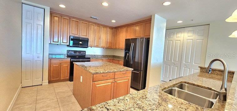 89 Vivante Boulevard, Unit 8942 Punta Gorda, FL 33950 - Photo 12 of 44 a kitchen with stainless steel appliances granite countertop a refrigerator stove and sink