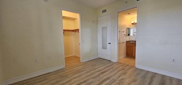 89 Vivante Boulevard, Unit 8942 Punta Gorda, FL 33950 - Photo 23 of 44 an empty room with wooden floor and a window