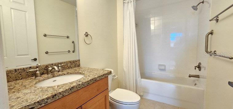 89 Vivante Boulevard, Unit 8942 Punta Gorda, FL 33950 - Photo 24 of 44 a bathroom with a granite countertop sink toilet and shower