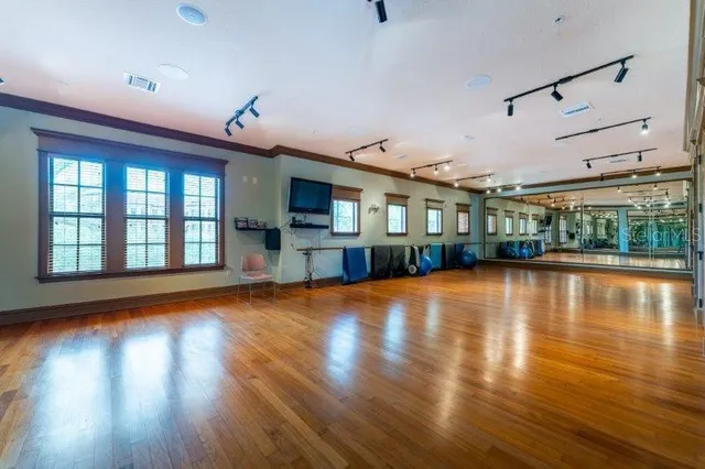 a view of a living room with hardwood floor fireplace and a window