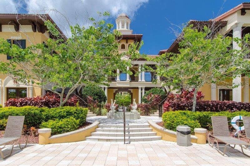 89 Vivante Boulevard, Unit 8942 Punta Gorda, FL 33950 - Photo 31 of 44 a front view of a house with a yard and potted plants