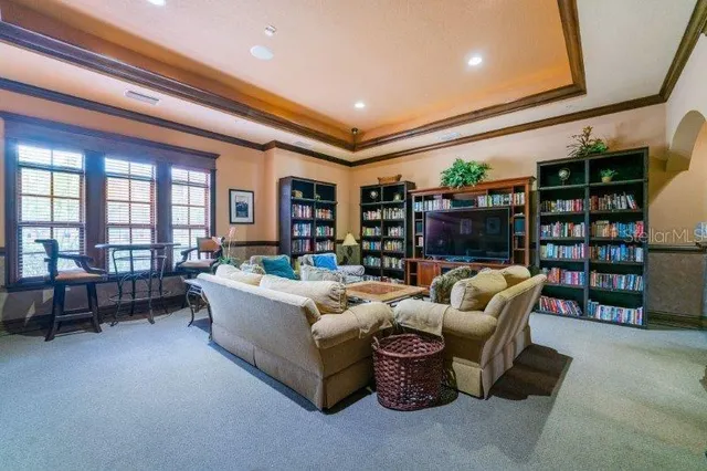 a living room with furniture and a book shelf