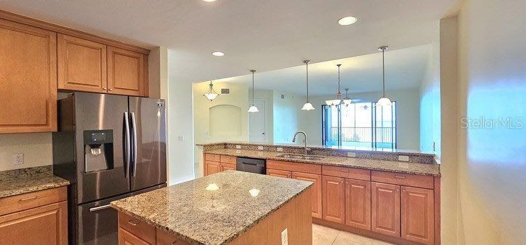 89 Vivante Boulevard, Unit 8942 Punta Gorda, FL 33950 - Photo 6 of 44 a kitchen with stainless steel appliances granite countertop a refrigerator and a sink