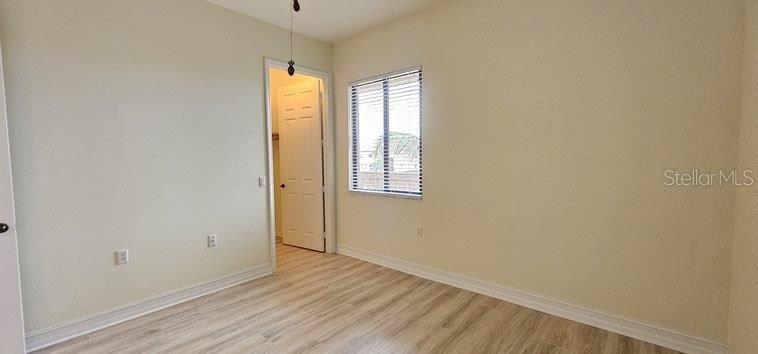 89 Vivante Boulevard, Unit 8942 Punta Gorda, FL 33950 - Photo 10 of 44 a view of an empty room with wooden floor and a window