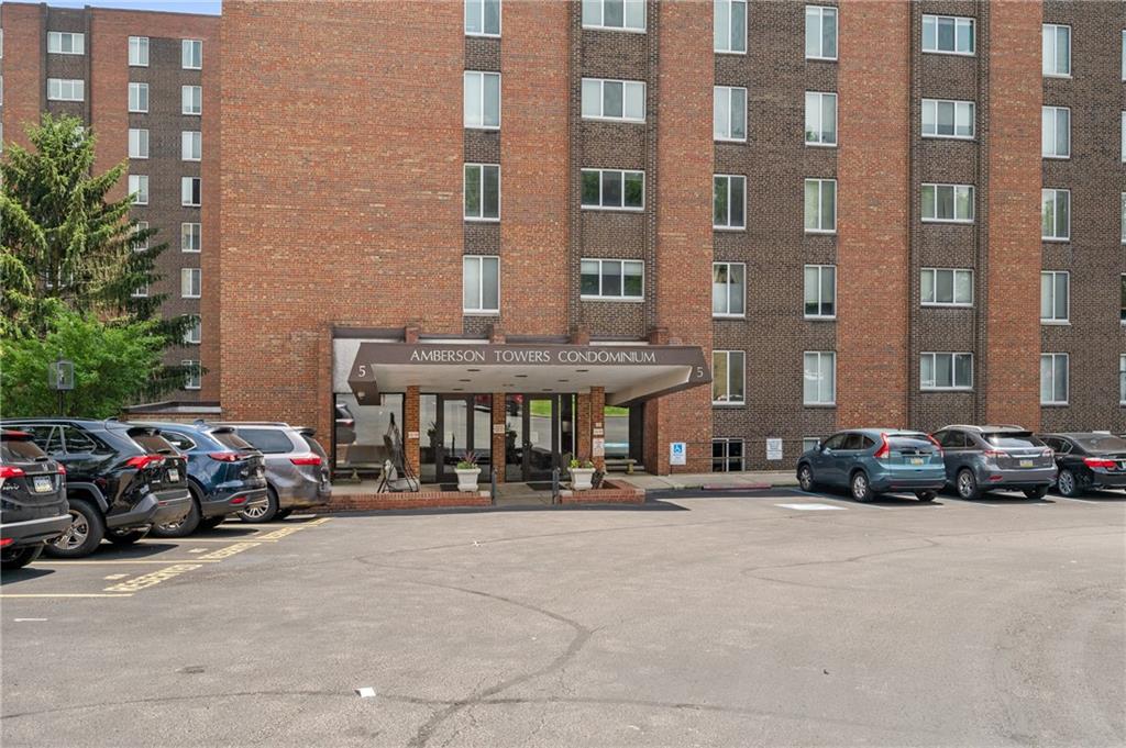 a cars parked in front of brick building