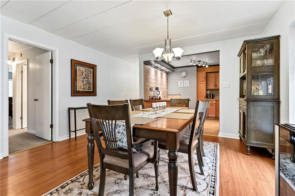 5 Bayard Road, Unit 203 Pittsburgh, PA 15213 - Photo 3 of 21 a view of a dining room with furniture wooden floor and chandelier