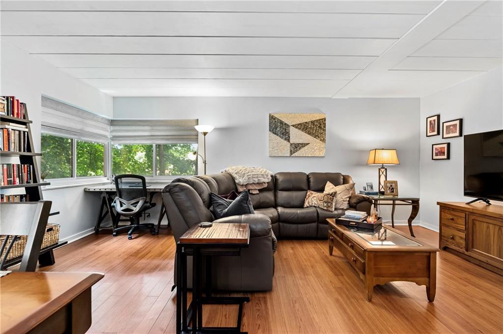 5 Bayard Road, Unit 203 Pittsburgh, PA 15213 - Photo 9 of 21 a living room with furniture a lamp wooden floor and a large window