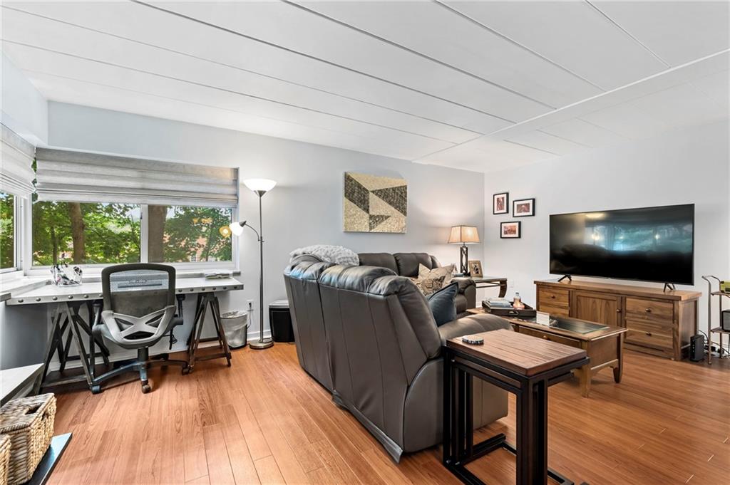 5 Bayard Road, Unit 203 Pittsburgh, PA 15213 - Photo 10 of 21 a living room with furniture and a flat screen tv