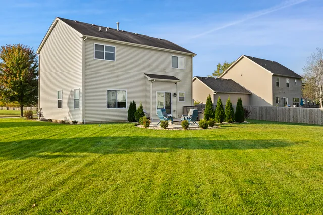 a front view of house with yard and green space