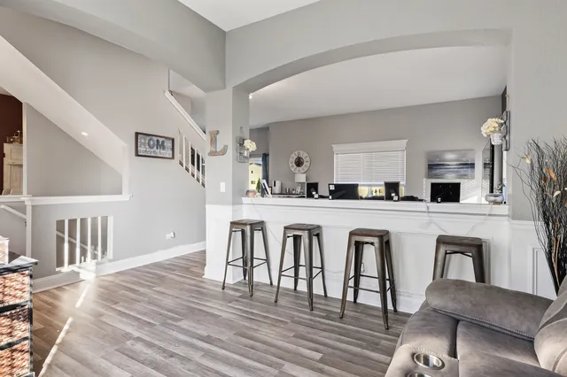 a kitchen with stainless steel appliances granite countertop a dining table chairs and granite counter tops