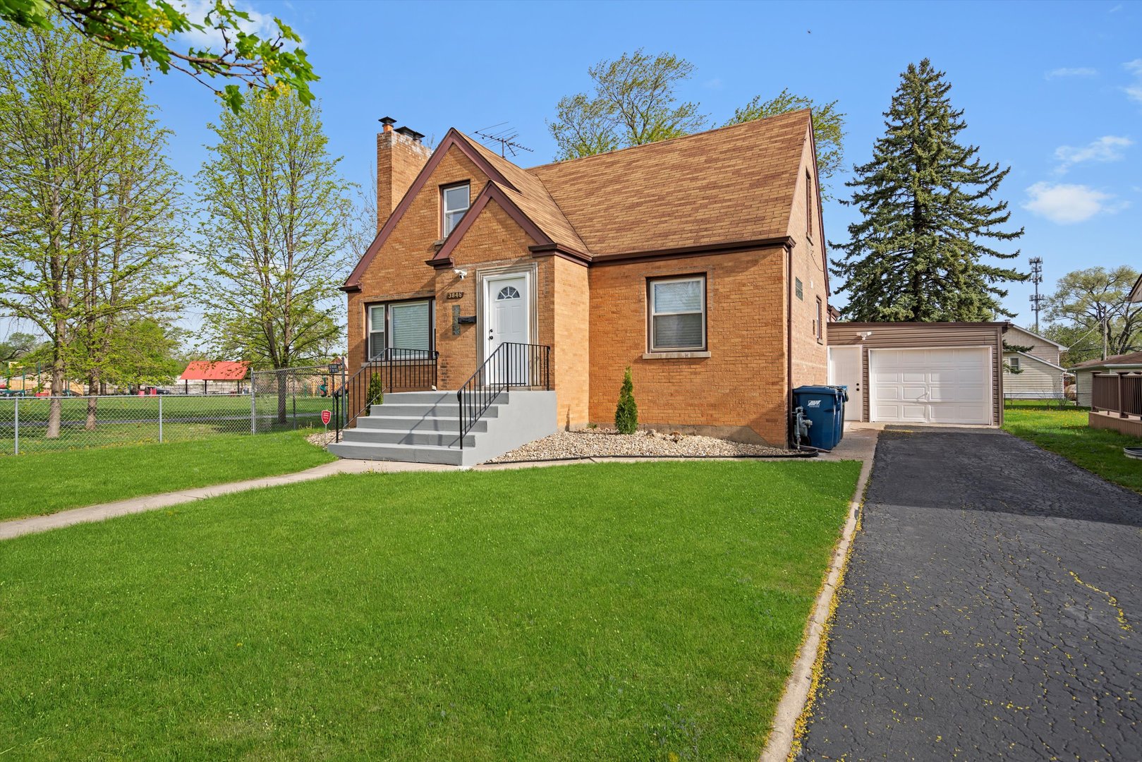 3846 149th Street Midlothian, IL 60445 - Photo 3 of 13 a front view of a house with a garden and trees
