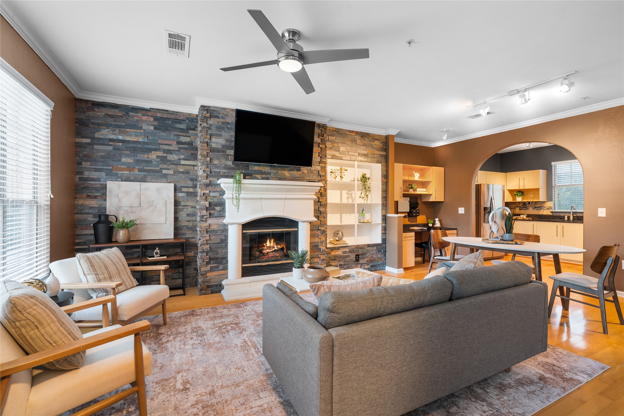 A striking stacked stone fireplace commands attention in this open living space on the second floor