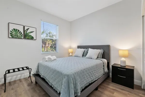 a bedroom with a bed and lamp