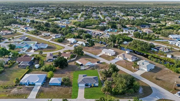 an aerial view of residential houses with outdoor space