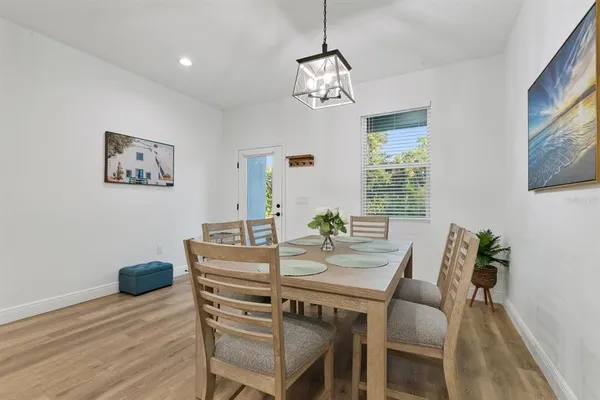 a view of a dining room with furniture and chandelier