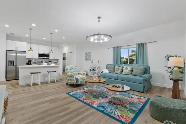 a living room with furniture and a chandelier