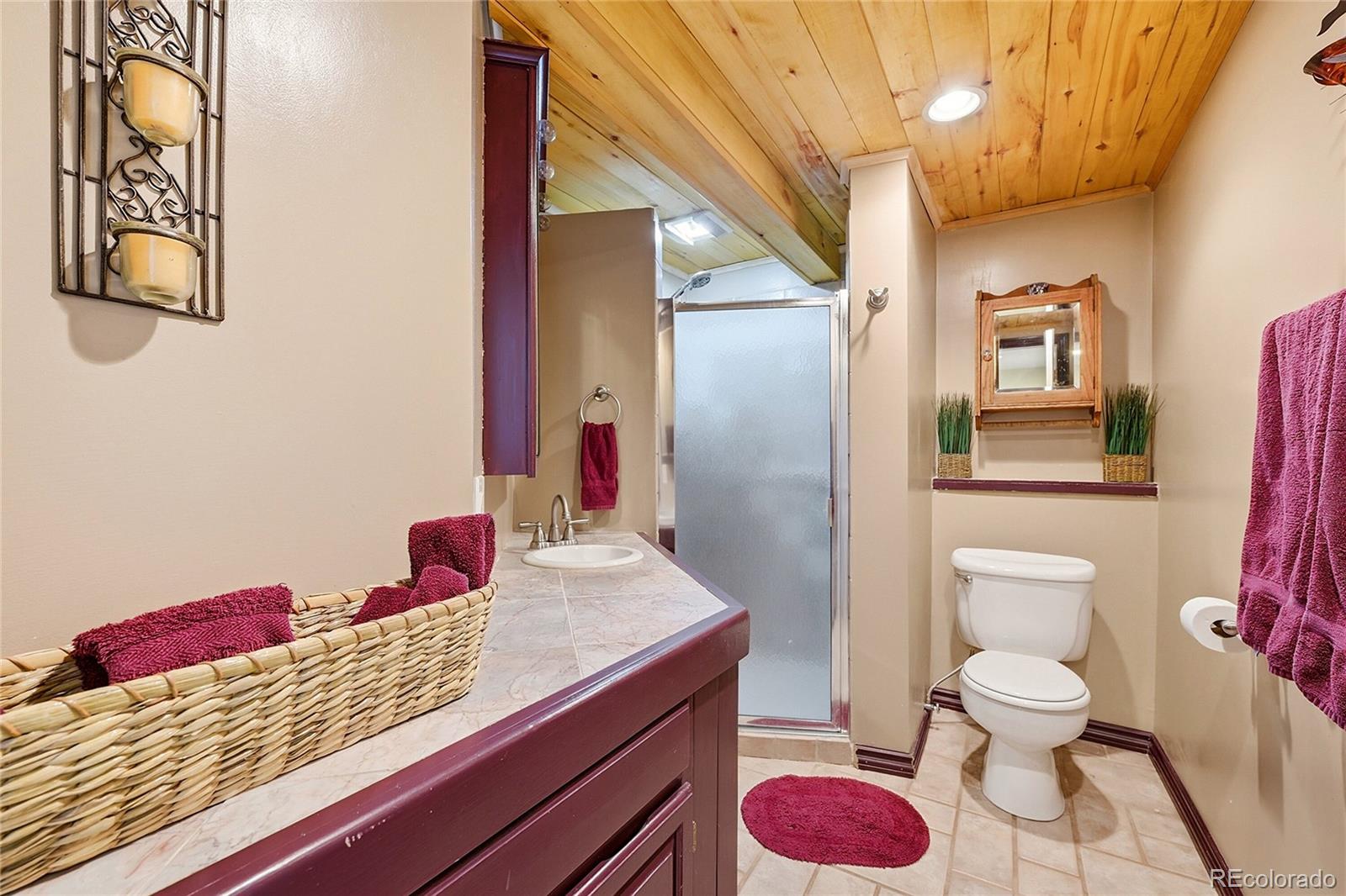 427 Brookside Drive Bailey, CO 80421 - Photo 33 of 37 a bathroom with a granite countertop sink and a mirror